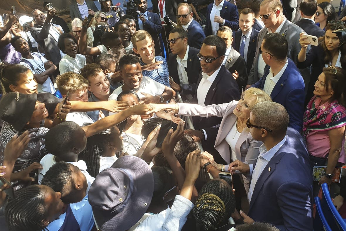 U.S. First lady Jill Biden, right, greets students while on a visit to the University of Science and Technology in Windhoek, Namibia, Friday, Feb. 24, 2023. Biden told the young people that the democracy their parents and grandparents fought for is now theirs to defend and protect. (AP Photo/Dirk Heinrich)