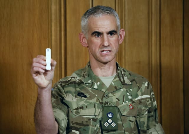 British Army Brigadier Joe Fossey, who is coordinating the mass coronavirus testing pilot in Liverpool, holds up the components of a lateral flow Covid-19 test (Tolga Akmen/PA)