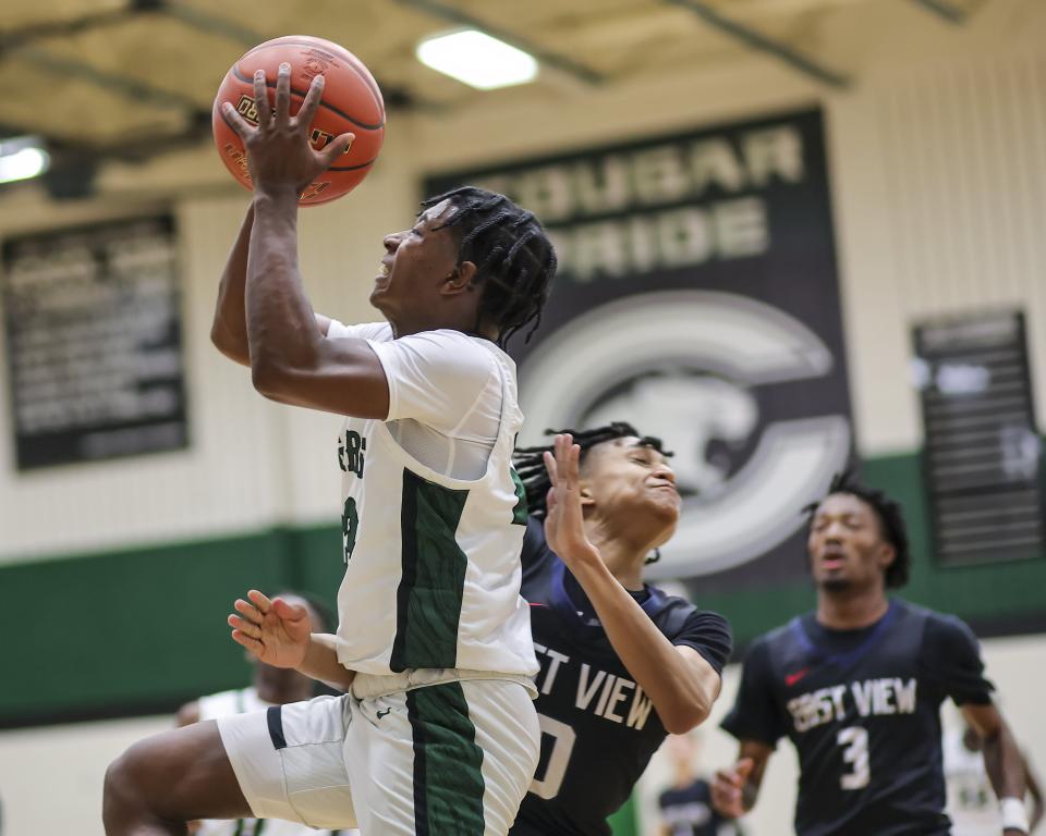 Connally's Jordan Wright barges past East View defender Jayden Prioleau for a basket during the Cougars' 62-53 win Friday night. But it's the team's defense, Wright said, that sets it apart. And he credited first-year coach John Howie. "He makes you play defense," Wright said. "That’s what we do; we want to be a defensive team, so we trust in the coaches and are buying in to what they’re saying."