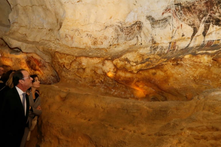 French President Francois Hollande and French Culture Minister Audrey Azoulay (R) visit Lascaux 4, a new replica of the prehistoric paintings of the Lascaux cave, in Montignac, on December 10, 2016