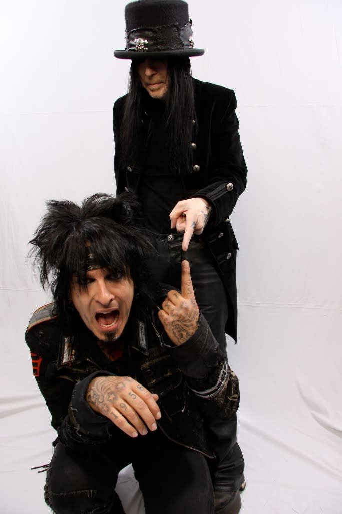 DONINGTON PARK, ENGLAND - JUNE 12: Nikki Sixx and Mick Mars of Motley Crue pose for a studio portrait session backstage at the Download Festival, Donington Park, Leicestershire on June 12th, 2009. (Photo by Mick Hutson/Redferns)