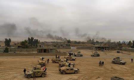 Military vehicles of the Iraqi army take part in a military operation against Islamic State militants in Qaryat Shayyalah Al Imam, Iraq November 30, 2016. REUTERS/Thaier Al-Sudani