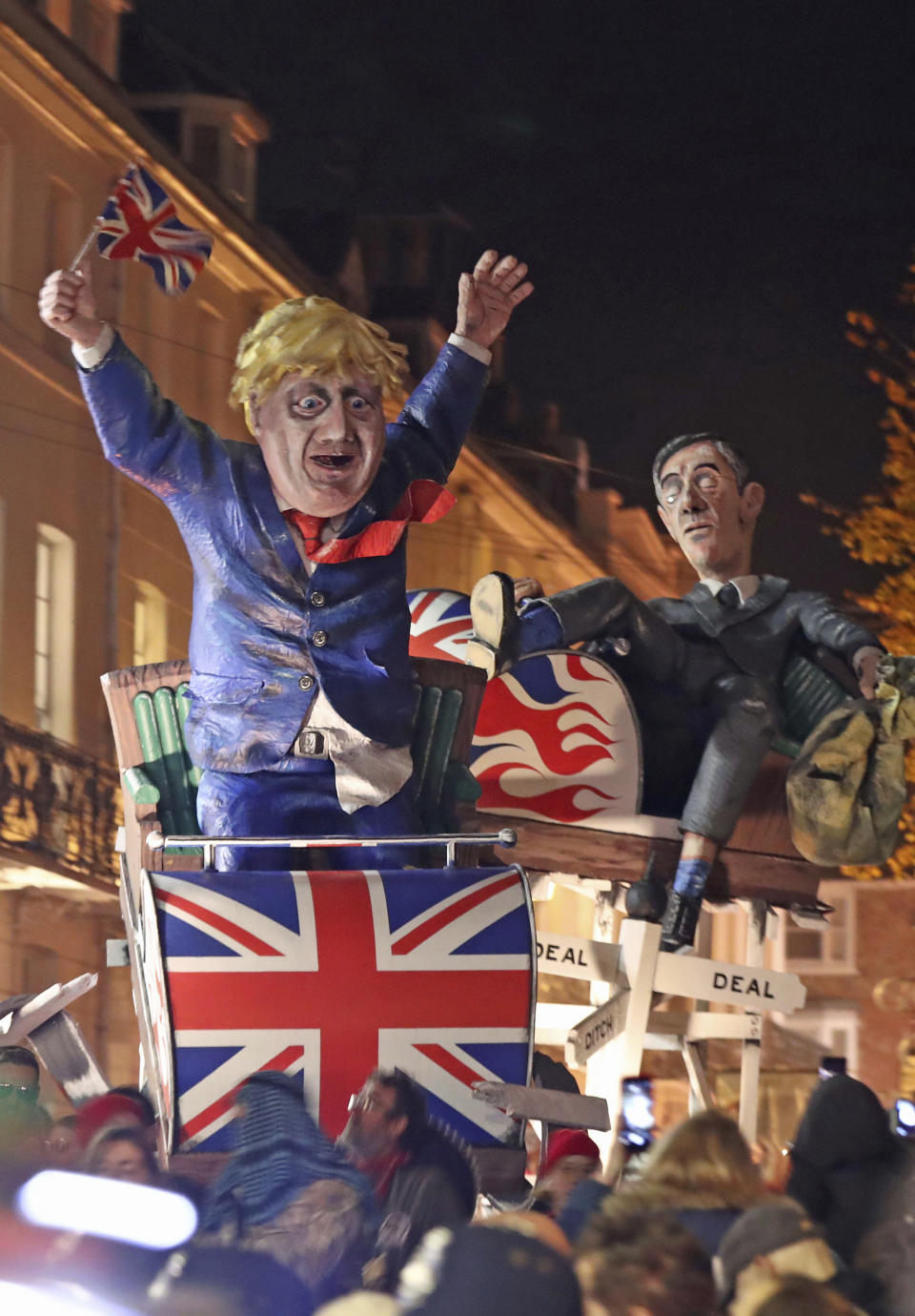 An effigy of Britain's Prime Minister Boris Johnson, left, and Leader of the House of Commons Jacob Rees-Mogg, during the annual bonfire night procession in the town of Lewes, Britain, Tuesday Nov. 5, 2019. The annual event traditionally includes high-profile political characters, with Britain's Brexit split with Europe being one of the main issues as the country goes to the polls in a General Election on Dec. 12. (Gareth Fuller/PA via AP)