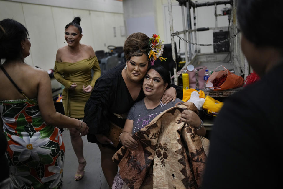 Brozlyn Lechelle, center, greets other performers backstage before the Mahu Magic drag show at the Western Regional Native Hawaiian Convention, Tuesday, June 20, 2023, in Las Vegas. (AP Photo/John Locher)