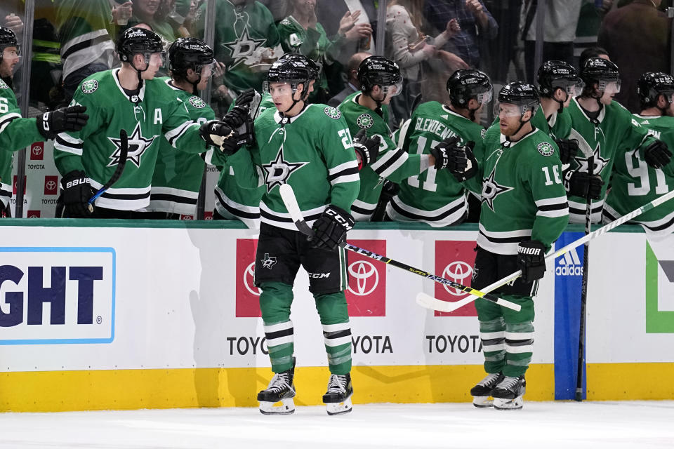 Dallas Stars' Jason Robertson (21) and Joe Pavelski (16) celebrate with the bench after Robertson scored in the second period of an NHL hockey game against the Boston Bruins, Tuesday, Feb. 14, 2023, in Dallas. (AP Photo/Tony Gutierrez)