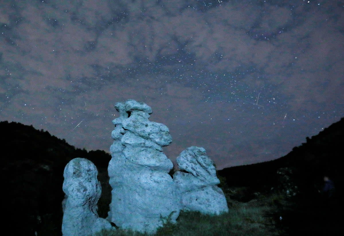 A meteor streaks during the Perseid meteor shower in the night sky over the village of Kuklici (REUTERS)