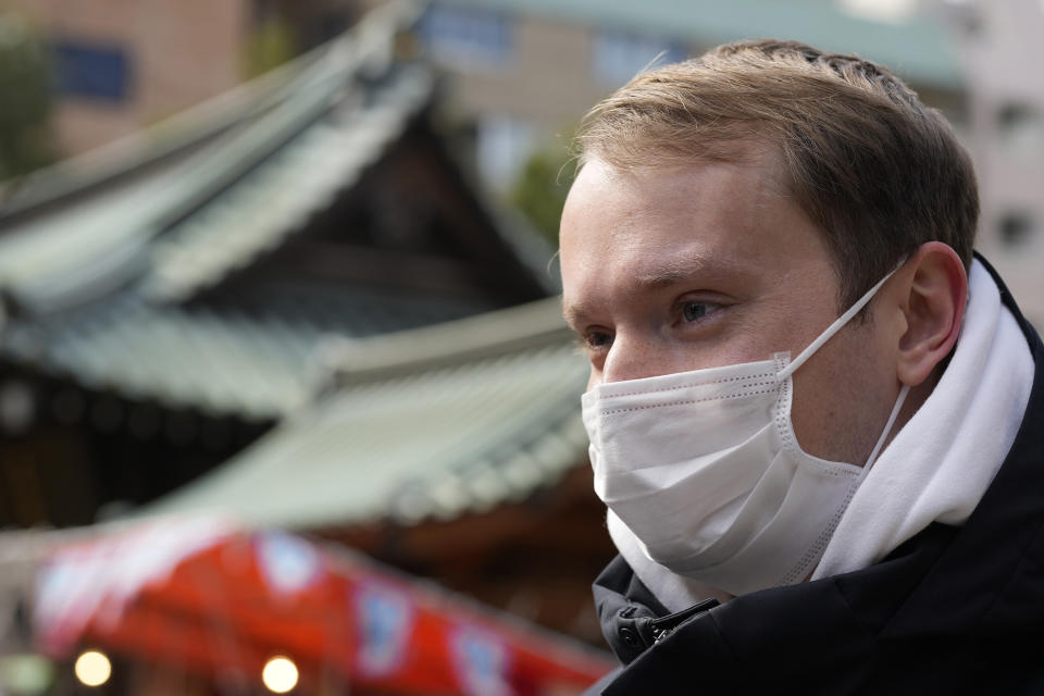 Ukrainian Dmytro Remez visits the Yushima Tenjin shrine on Feb. 15, 2023, in Tokyo, Japan. Remez, 24, a fledgling medical doctor studying at Juntendo University, is among the 2,291 Ukrainians who have moved to Japan since the war with Russia began a year ago. (AP Photo/Shuji Kajiyama)