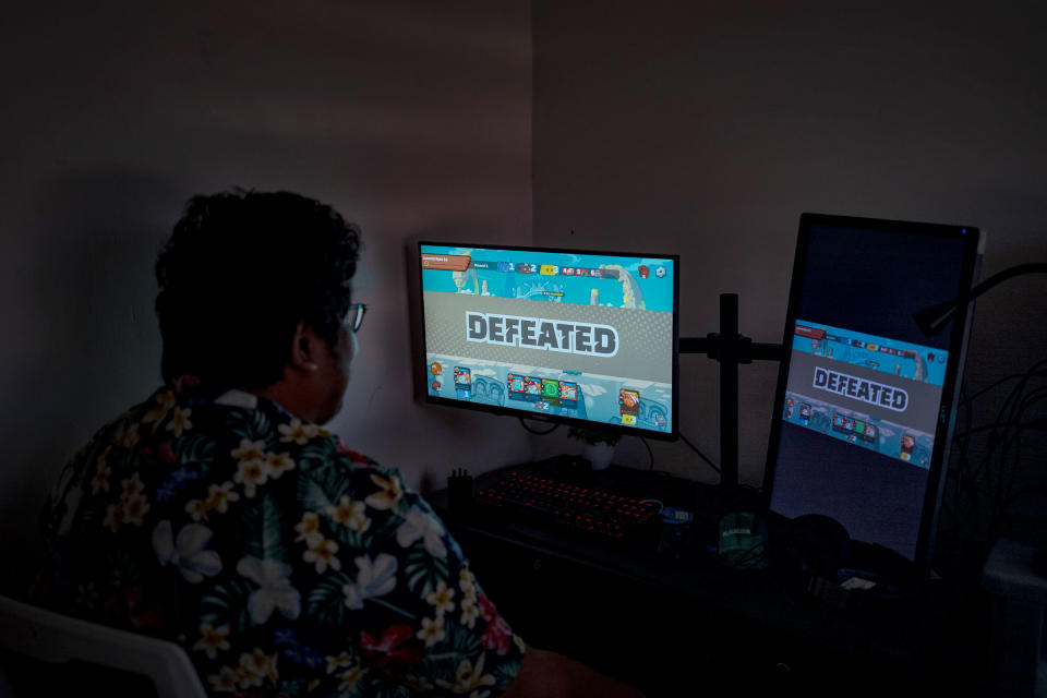 Albert Oasnon, an Axie "manager", plays the game at his home in Imus, Cavite, in the outskirts of Manila, Philippines, on July 19, 2022. Oasnon, who works in content marketing and also runs a small media company, says that during the game's peak last year, he was managing around 20 scholars.<span class="copyright">Ezra Acayan for TIME</span>