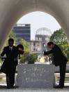 <p>Hiroshima Mayor Kazumi Matsui, right, hands over the name list of newly added people who died of the world’s first atomic bombing over the past year during a ceremony to mark the 72nd anniversary of the 1945 bombing that killed 140,000 people, at the Peace Memorial Park in Hiroshima, western Japan, Sunday, Aug. 6, 2017. “This hell is not a thing of the past,” Matsui said in his peace declaration at Sunday’s ceremony. “As long as nuclear weapons exist and policymakers threaten their use, their horror could leap into our present at any moment. You could find yourself suffering their cruelty.” (Photo: Shohei Miyano/Kyodo News via AP) </p>