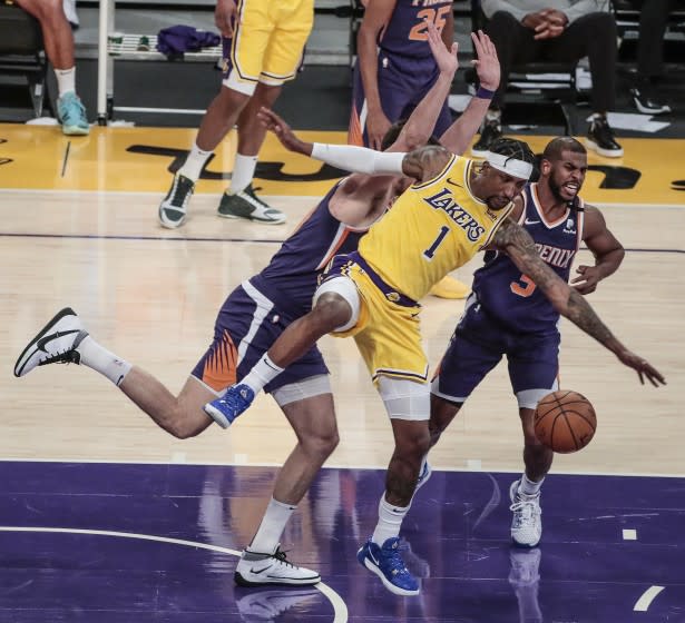 Lakers' Kentavious Caldwell-Pope is stripped of the ball by Phoenix Suns' Chris Paul as he bumps into Dario Saric