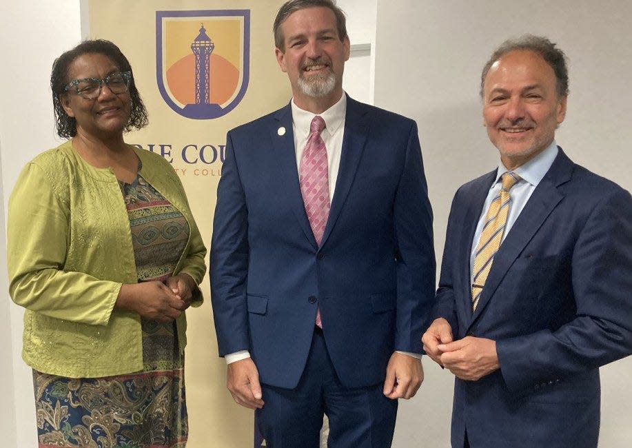 Erie County Community College President Christopher Gray, center, is shown, July 8, 2021, with Cheryl Rush-Dix, vice chairman of the college's board of trustees, left, and Ron DiNicola, trustees chairman, right.