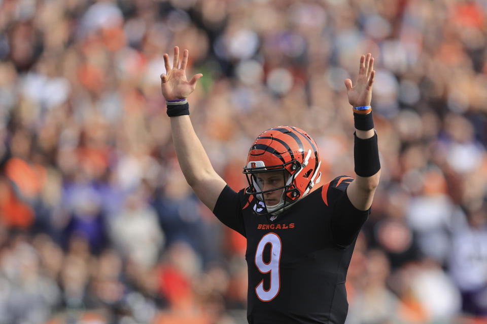 Cincinnati Bengals quarterback Joe Burrow (9) reacts after a touchdown run by Joe Mixon during the first half of an NFL football game against the Baltimore Ravens, Sunday, Dec. 26, 2021, in Cincinnati. (AP Photo/Aaron Doster)