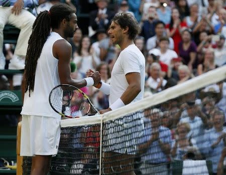 Dustin Brown of Germany shakes hands with Rafael Nadal of Spain after winning their match at the Wimbledon Tennis Championships in London, July 2, 2015. REUTERS/Stefan Wermuth