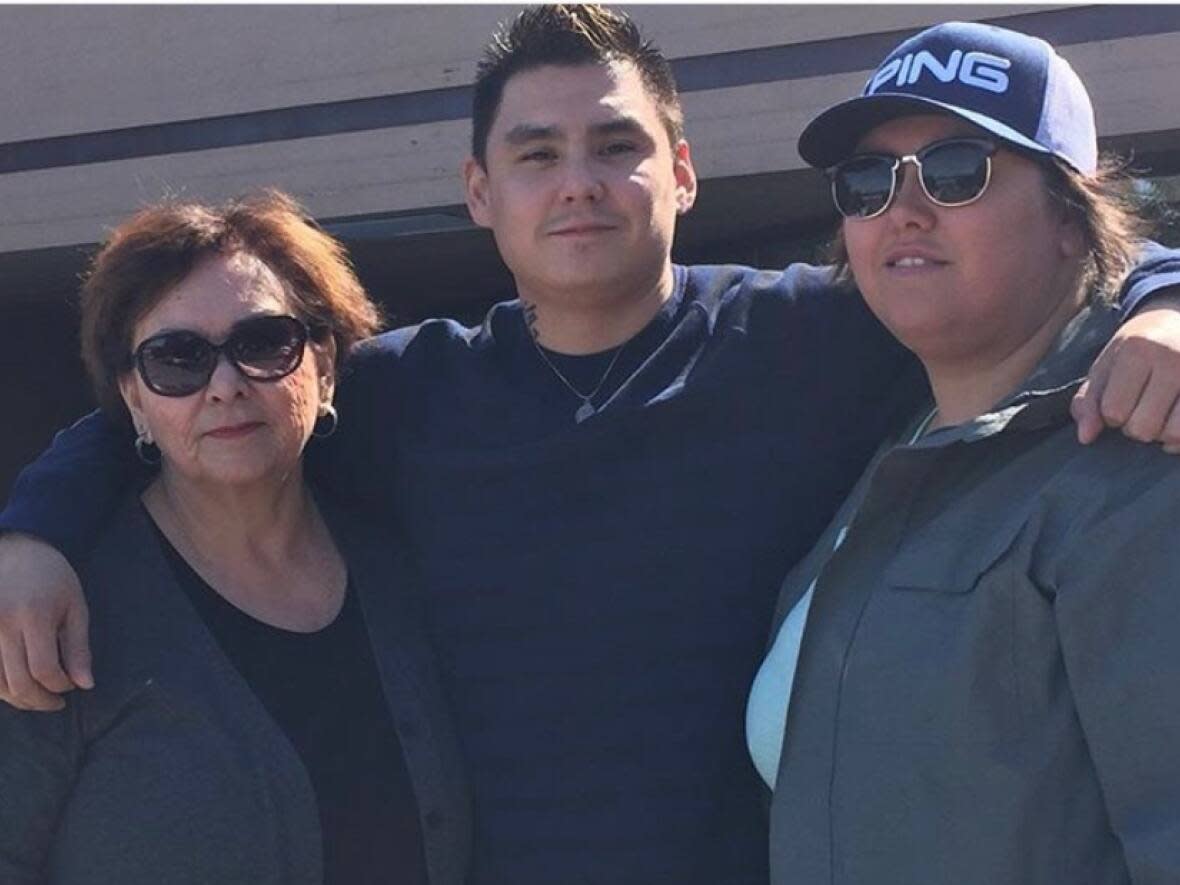 RCMP said Lane Tailfeathers — pictured here with his mother, left, and sister Tannis — was reported missing by his family on June 20, 2021. His remains were found a month later. (Submitted by Tannis Tailfeathers - image credit)