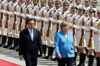 German Chancellor Angela Merkel and Chinese Premier Li Keqiang review the guard of honour during a welcome ceremony outside the Great Hall of the People in Beijing, China May 24, 2018. REUTERS/Jason Lee