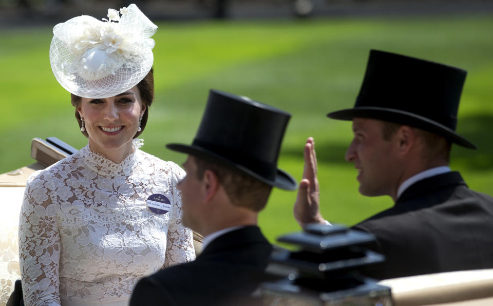 FILE - In this Tuesday, June 20, 2017 file photo, Britain's Kate, Duchess of Cambridge, left, smiles as she travels with Prince William, right, and Prince Edward in a open carriage to the parade ring on the first day of the Royal Ascot horse race meeting in Ascot, England. Prince Philip was the longest serving royal consort in British history. In Britain, the husband or wife of the monarch is known as consort, a position that carries immense prestige but has no constitutional role. The wife of King George VI, who outlived him by 50 years, was loved as the Queen Mother. Prince Charles’ wife, Camilla, has worked to emerge from the shadow of his immensely popular first wife, Diana. (AP Photo/Alastair Grant, File)