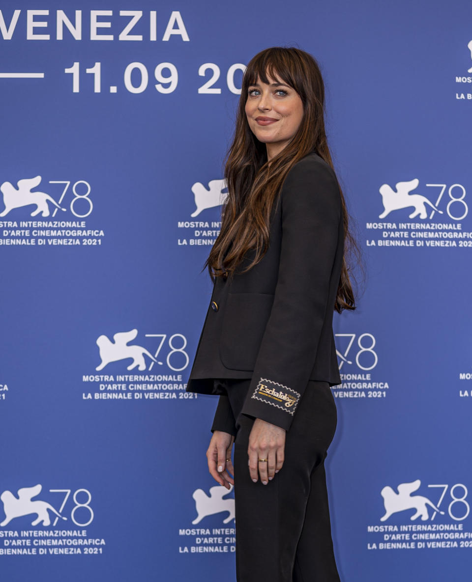 Dakota Johnson poses for photographers at the photo call for the film 'The Lost Daughter' during the 78th edition of the Venice Film Festival in Venice, Italy, Friday, Sep, 3, 2021. (AP Photo/Domenico Stinellis)