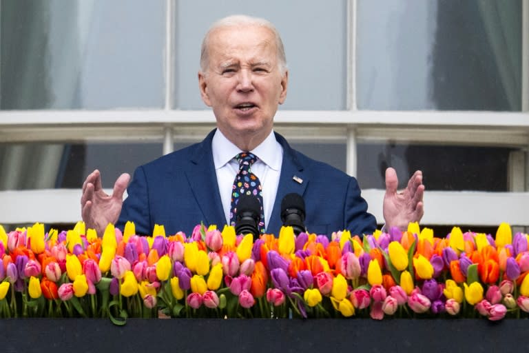 US President Joe Biden speaks from the balcony of the White House during the annual Easter Egg Roll on the South Lawn in Washington, DC, on April 1, 2024. (Jim WATSON)