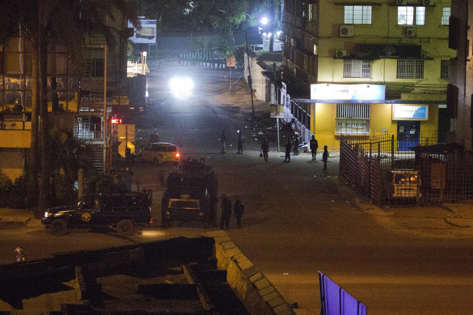 Congolese riot police take position around the electoral commission building at night in Kinshasa, Congo, Tuesday Jan. 8, 2019. As Congo anxiously awaits the outcome of the presidential election, many in the capital say they are convinced that the opposition won and that the delay in announcing results is allowing manipulation in favor of the ruling party. (AP Photo/Jerome Delay)