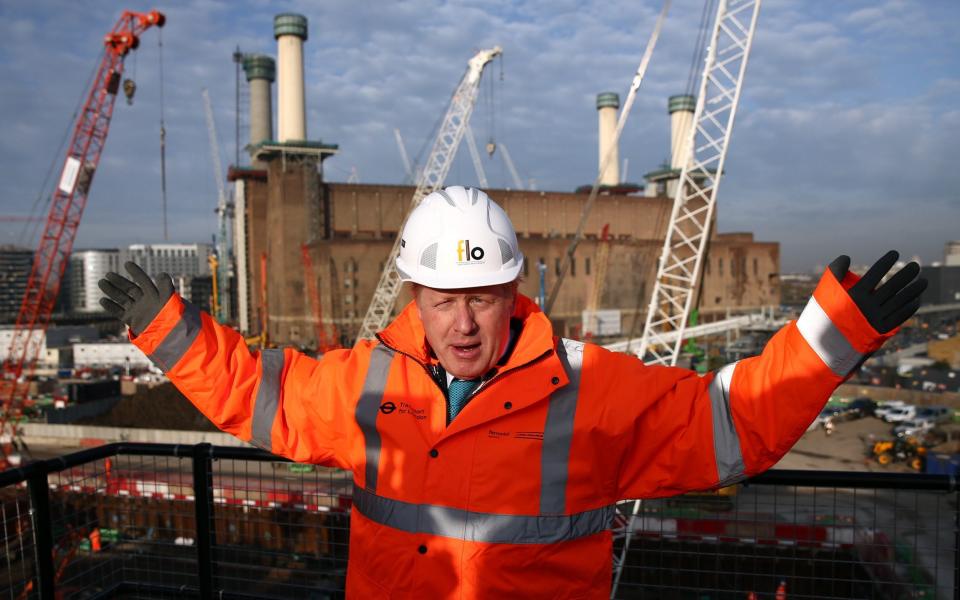 Boris Johnson, then Mayor of London, poses for a photograph at Battersea Power Station in 2015 to mark the start of construction of new tube stations connecting Battersea and Nine Elms to the London Underground network - Getty