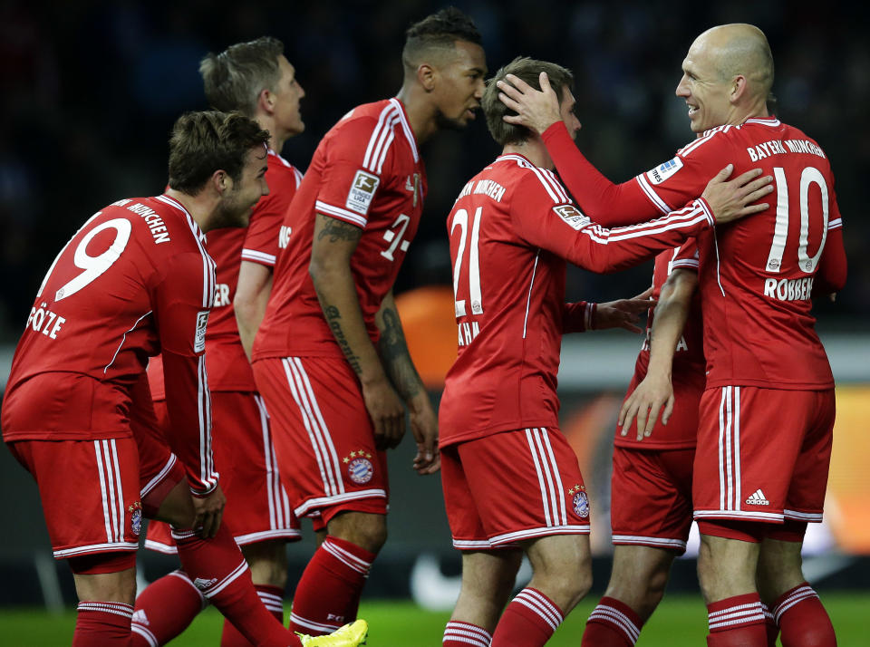 Bayern's Arjen Robben of the Netherlands, right, and scorer Mario Goetze, left, smile as they celebrate their side's second goal during the German Bundesliga soccer match between Hertha BSC Berlin and Bayern Munich in Berlin, Germany, Tuesday, March 25, 2014. (AP Photo/Michael Sohn)