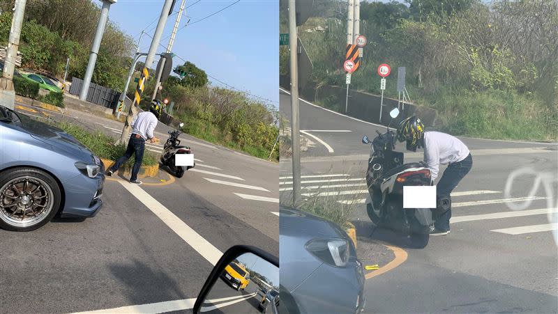 騎士把車停在安全島旁，站一段時間後，將疑遭路殺的貓屍放進紙箱。（圖／翻攝自 新竹爆料公社）