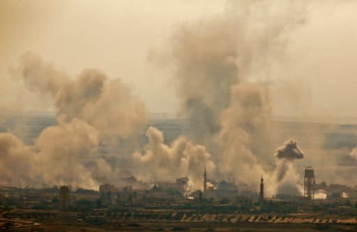 A picture taken on July 16, 2018 from the Israeli side in the annexed Golan Heights, shows smoke plumes rising from reported Syrian and Russian air strikes across the border in Syria's southern Quneitra province
