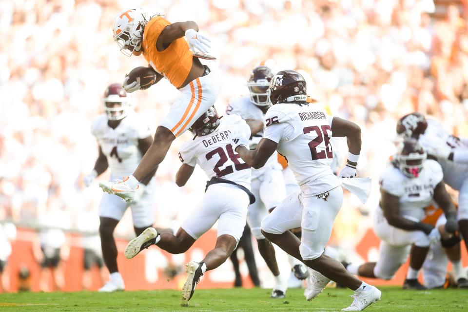 Tennessee running back Jaylen Wright (0) hurdles Texas A&M defensive back Demani Richardson (26) during a football game between Tennessee and Texas A&M at Neyland Stadium in Knoxville, Tenn., on Saturday, Oct. 14, 2023.