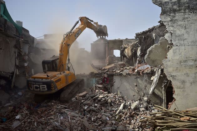 After two nights in police custody, Indian teenager Somaiya Fatima was released in time to watch live footage of an excavator claw smashing into the walls of her childhood home. The residence is among scores of dwellings and businesses flattened by wrecking crews this year in India. (Photo: SANJAY KANOJIA via Getty Images)