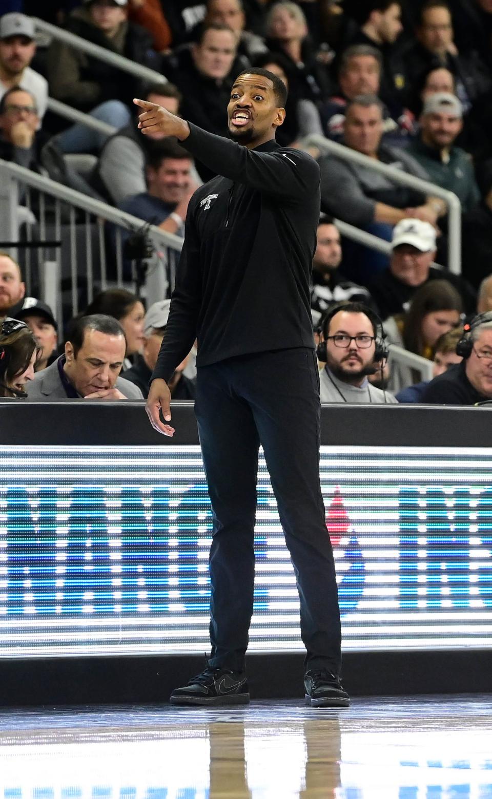 Friars head coach Kim English reacts to game action during the first half Tuesday night at Amica Mutual Pavilion.