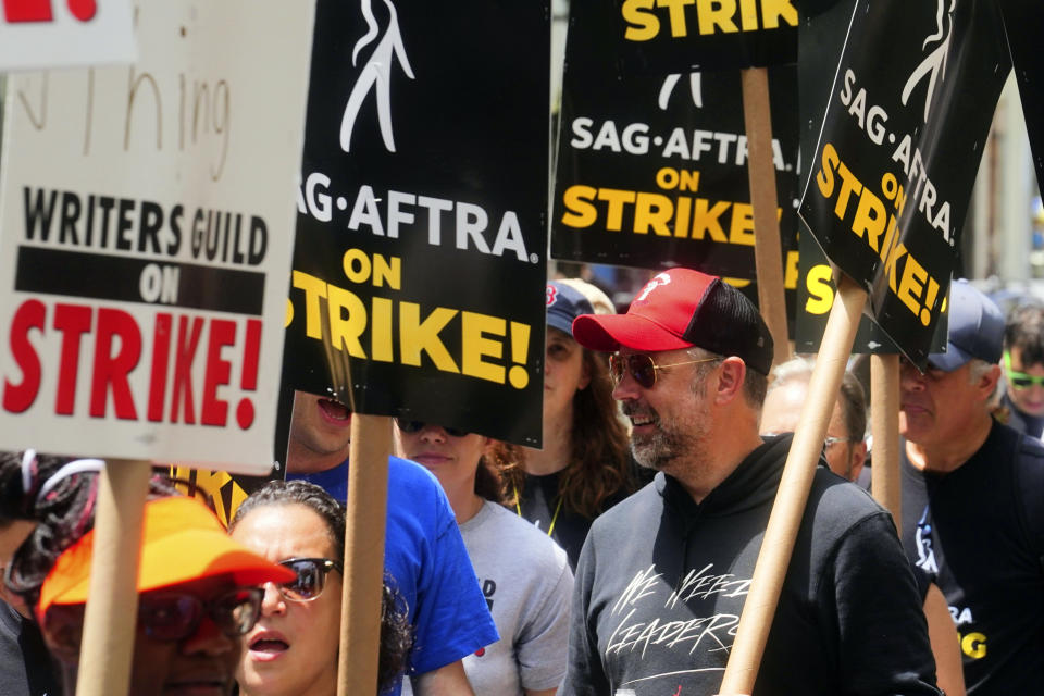 Actor Jason Sudeikis, center, walks a picket line with striking writers and actors, Friday, July 14, 2023, at NBC Universal Studios in New York. The picketing comes a day after the main actors’ union voted to join screenwriters in a double-barreled strike for the first time in more than six decades. The dispute immediately shut down production across the entertainment industry after talks for a new contract with studios and streaming services broke down. (AP Photo/Bebeto Matthews)