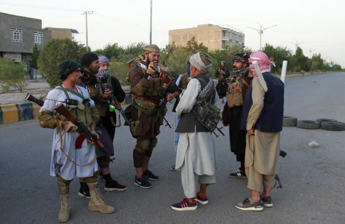 Private militia loyal to Ismail Khan, the former Mujahideen commander, talks with each others and patrols after security forces took back control of parts of Herat city following fighting between Taliban and Afghan security forces in Herat province, west of Kabul, Afghanistan, Friday, Aug. 6, 2021. (AP Photo/Hamed Sarfarazi)