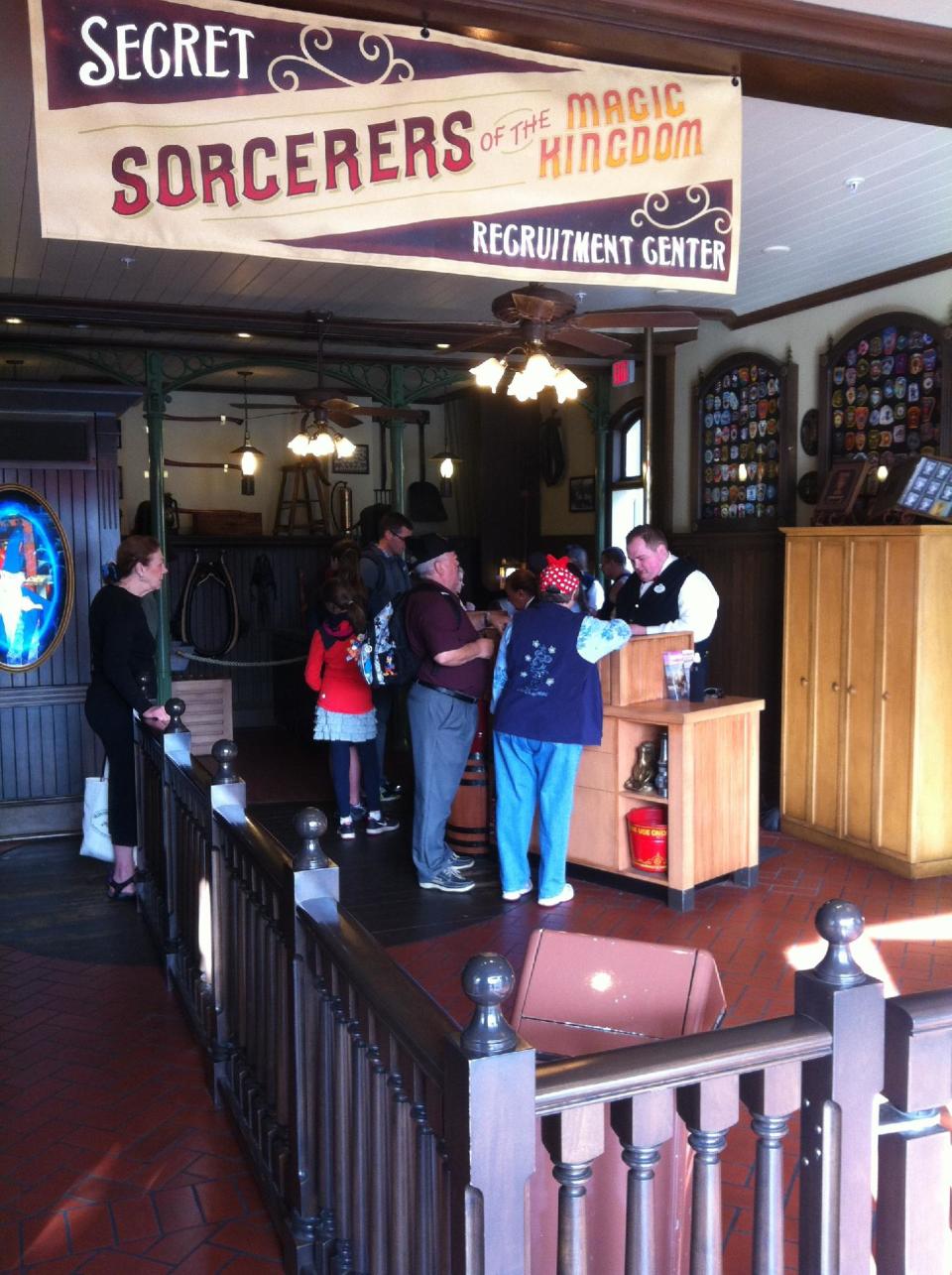 In this Feb. 15, 2013 photo, prospective participants line up to play the "Sorcerers of the Magic Kingdom" game at Walt Disney World's Magic Kingdom theme park in Lake Buena Vista, Fla. The "Sorcerers" game and others like it represent a recent push by Disney World to provide its guests with attractions that allow them to interact with their favorite characters. (AP Photo/Mike Householder)