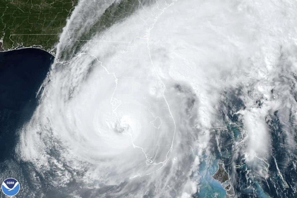This satellite image taken at 3:06 p.m. EDT and provided by NOAA shows Hurricane Ian making landfall in southwest Florida near Cayo Costa, Fla., on Wednesday, Sept. 28, 2022, as a catastrophic Category 4 storm. (NOAA via AP)