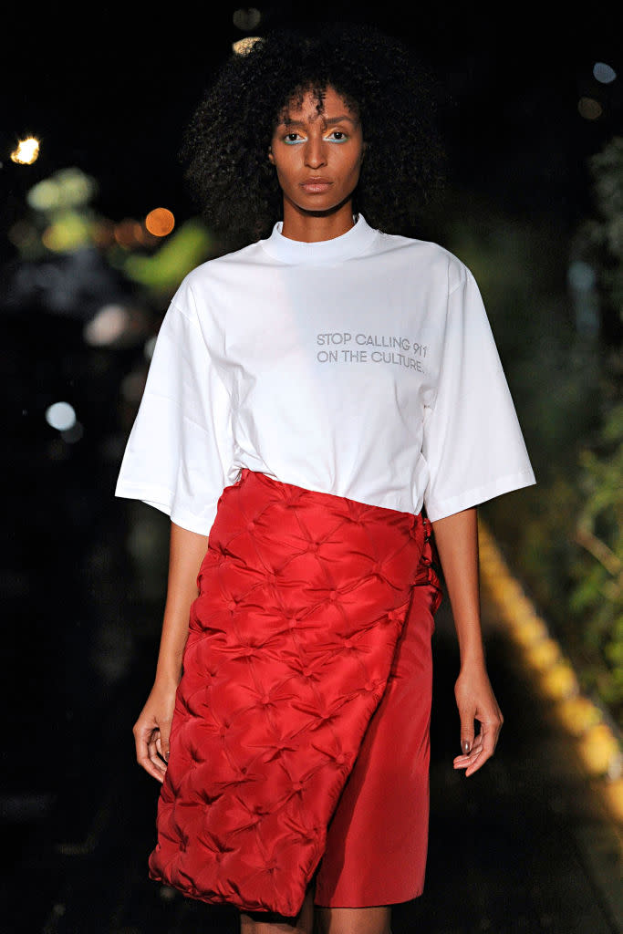 <p>During Pyer Moss’s SS19 show, designer Kerby Jean-Raymond made a powerful political statement by presenting a T-shirt that read, “Stop calling 911 on the culture.” This is a reference to the several cases within the past year when police were called on black men and women. Two notable examples took place in April, when a white woman <a rel="nofollow noopener" href="https://www.huffingtonpost.com/entry/woman-calls-police-oakland-barbecue_us_5af50125e4b00d7e4c18f741" target="_blank" data-ylk="slk:called the police on a black family having a barbecue;elm:context_link;itc:0;sec:content-canvas" class="link ">called the police on a black family having a barbecue</a> in Oakland, Calif., and when two black men were waiting for a friend at <a rel="nofollow" href="https://www.yahoo.com/news/starbucks-ceo-apologizes-reprehensible-arrest-two-black-men-171245155.html" data-ylk="slk:Starbucks and an employee called 911;elm:context_link;itc:0;sec:content-canvas;outcm:mb_qualified_link;_E:mb_qualified_link;ct:story;" class="link  yahoo-link">Starbucks and an employee called 911</a>. (Photo: Getty) </p>