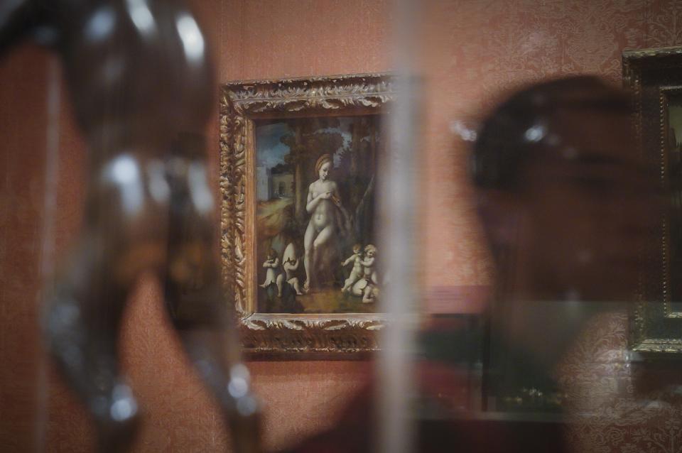 An oil on wood painting, center, by Italian artist Bachiacca, "Leda and the Swan"—a 1982 acquisition from the Jack and Belle Linsky Collection to the Metropolitan Museum of Art—is shown on exhibition at the museum Thursday, Sept. 1, 2022, in New York. The painting is among 53 works in the museum's collection, once looted during the Nazi era, but returned to their designated owners before being obtained by the museum through donation or sale. (AP Photo/Bebeto Matthews)