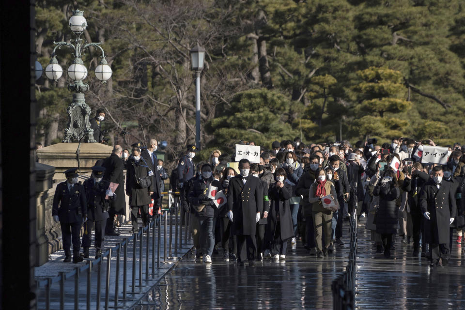 Well-wishers arrive for the New Year's appearance by the Japanese royal family at the Imperial Palace in Tokyo Monday, Jan. 2, 2023. The event was held for the first time in three years, following a hiatus due to the coronavirus pandemic. (Tomohiro Ohsumi/Pool Photo via AP)