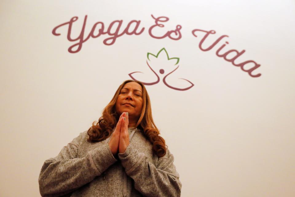 Tahais Martins begins class with a session of meditation at the newly opened Yoga es Vida at the Killburn Mill in New Bedford.