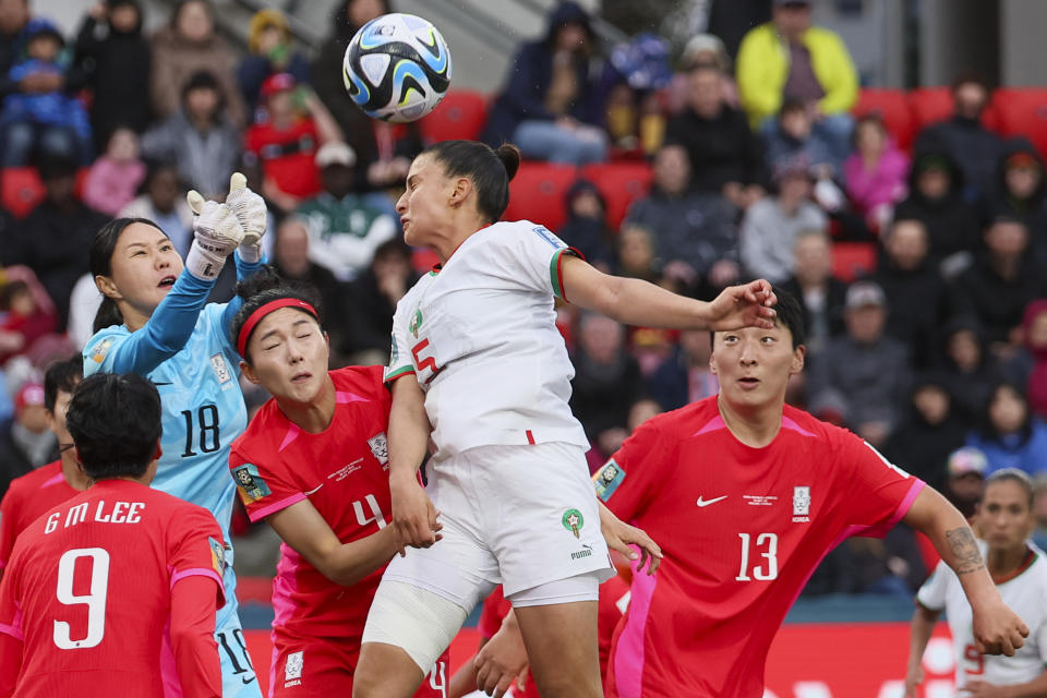 South Korea's goalkeeper Kim Jung-mi, left, punches the bal clear of Morocco's Nesryne El Chad during the Women's World Cup Group H soccer match between South Korea and Morocco in Adelaide, Australia, Sunday, July 30, 2023. (AP Photo/James Elsby)