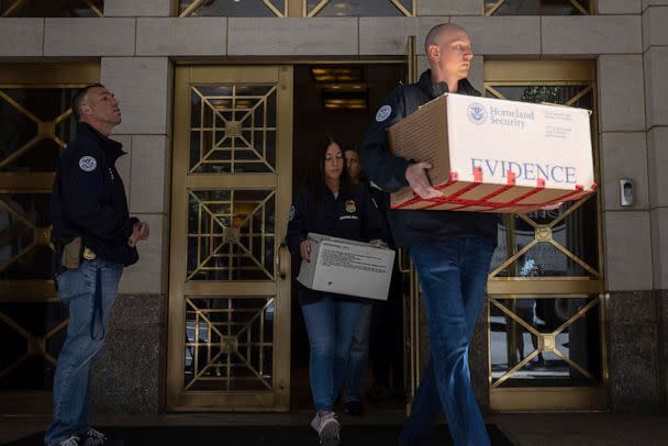 PHOTO: Federal agents carry evidence boxes as they walk out of a Park Avenue high-rise on Sep. 1, 2022, in New York. (Yuki Iwamura/AP, FILE)