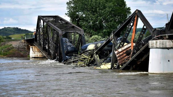 PHOTO: Several train cars are immersed in the Yellowstone River after a bridge collapse near Columbus, Montana, on June 24, 2023. (Matthew Brown/AP)