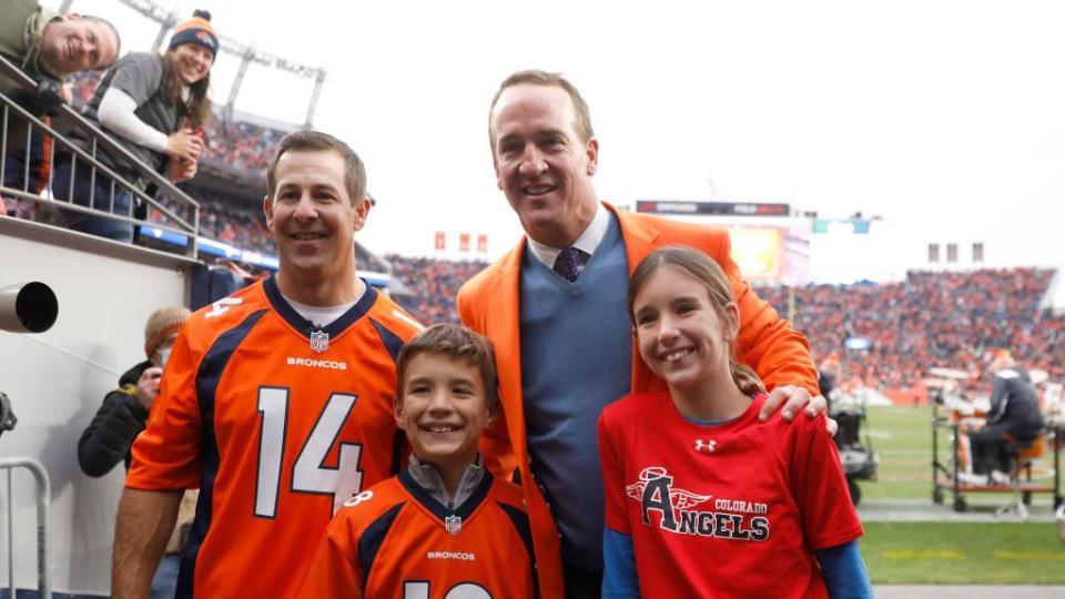 denver, colorado october 31 brandon stokely, peyton manning, marshall manning, and mosley manning pose for photos during a ring of honor induction ceremony at halftime of the game between the washington football team and denver broncos at empower field at mile high on october 31, 2021 in denver, colorado photo by justin edmondsgetty images