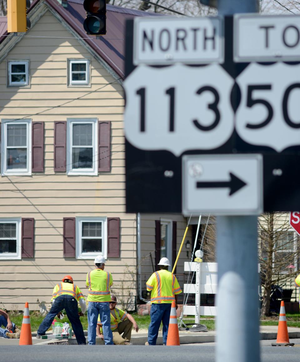 Workers install sidewalks to the area of Bay Street and Route 113 in Berlin last year. A new crosswalk signal has now been installed and a community appreciation event is set Friday to mark the safety improvements.