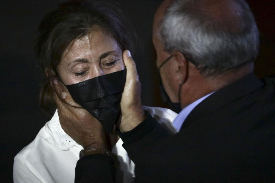 Former Colombian Presidential candidate Ingrid Betancourt, left, who was abducted while campaigning by the Revolutionary Armed Forces of Colombia, FARC, rebels, is comforted by another kidnapping victim during an event at the Truth Commission to commemorate victims of the country’s decades long armed conflict, in Bogota, Colombia, Wednesday, June 23, 2021. (AP Photo/Ivan Valencia)