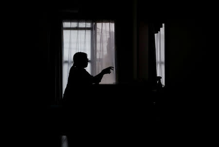 Miwa Moriya is silhouetted while she speaks during an interview with Reuters at her house in Yokohama, Japan, April 24, 2019. Picture taken April 24, 2019. REUTERS/Kim Kyung-hoon