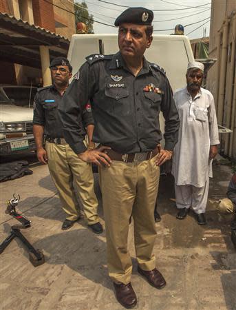 Shafqat Malik (C), head of a police bomb disposal unit, watches while his team display their equipment during a demonstration at the unit's headquarters in Peshawar September 11, 2013. REUTERS/Zohra Bensemra