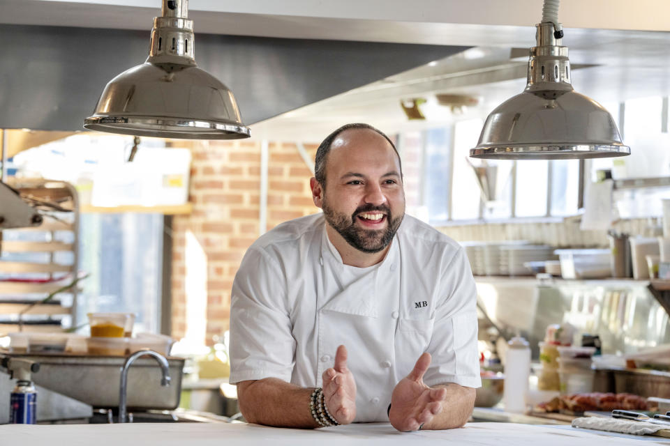 Matt Baker, chef and owner of Gravitas, poses for a portrait inside the restaurant, Tuesday, Feb. 14, 2023, in Washington. Gravitas has a subscription service offering a monthly meal for two. (AP Photo/Jacquelyn Martin)