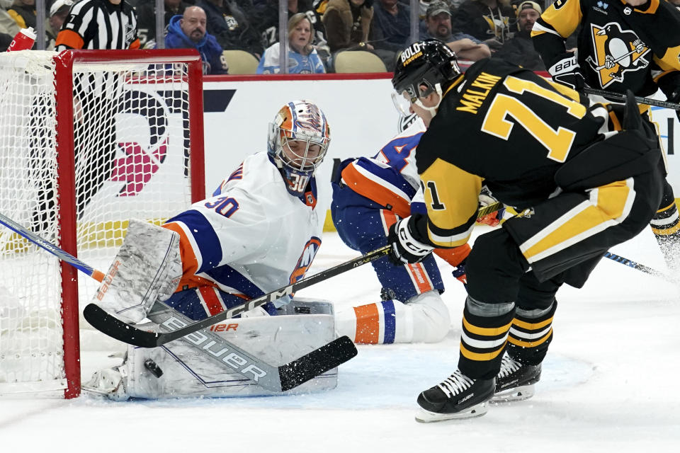 New York Islanders goaltneder Ilya Sorokin (30) makes a save against Pittsburgh Penguins' Evgeni Malkin (71) during the second period of an NHL hockey game Sunday, Dec. 31, 2023, in Pittsburgh. (AP Photo/Matt Freed)