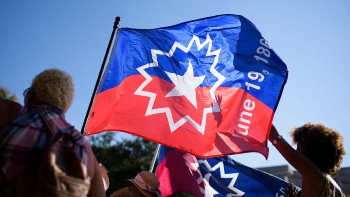 People carry a Juneteenth flag as they march during a Juneteenth re-enactment celebration in Galveston, Texas on June 19, 2021. (Photo: Mark Felix/AFP via Getty Images)