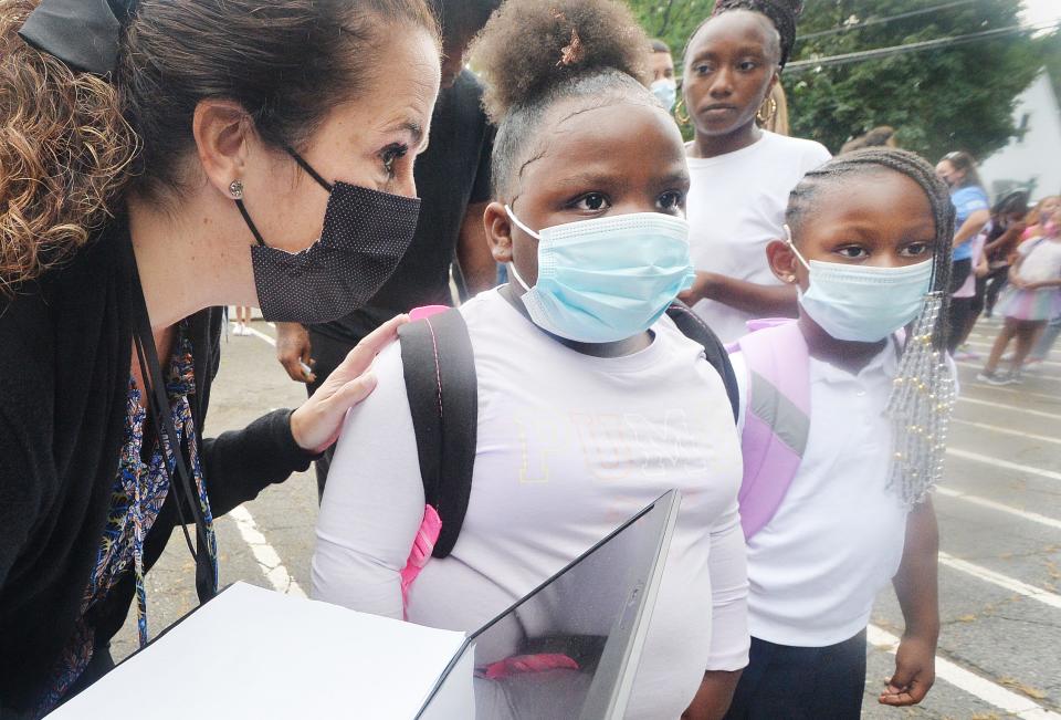 Diane Sutton, left, the principal at the Erie School District's Edison Elementary School, helps kindergarteners on Aug. 30, the first day of school in the 2021-22 academic year. The Erie School District required students to wear masks, in keeping with what was then a countywide policy during the COVID-19 pandemic.